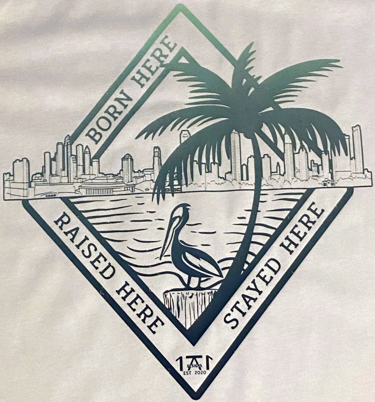 tampa bay native design on a white t shirt featuring the tampa skyline and st. pete skyline with the phrase born here raised here stayed here keepin it local